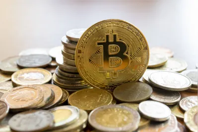 SÃ£o Paulo, Brazil - December 2, 2021: Bitcon currency rising amidst several currencies. Virtual cryptocurrency concept. Bitcoin is a digital asset, used to buy and sell products and services over the internet.
