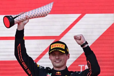 Red Bull's Dutch driver Max Verstappen celebrates with the trophy after winning the Formula One Azerbaijan Grand Prix at the Baku City Circuit in Baku on June 12, 2022. (Photo by NATALIA KOLESNIKOVA / AFP)