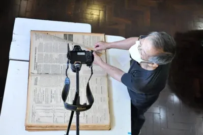 A digitalização é feita com o auxílio de uma máquina fotográfica. Depois, o material é transferido para um editor de imagens e salvo em formato PDF para permitir a leitura do texto