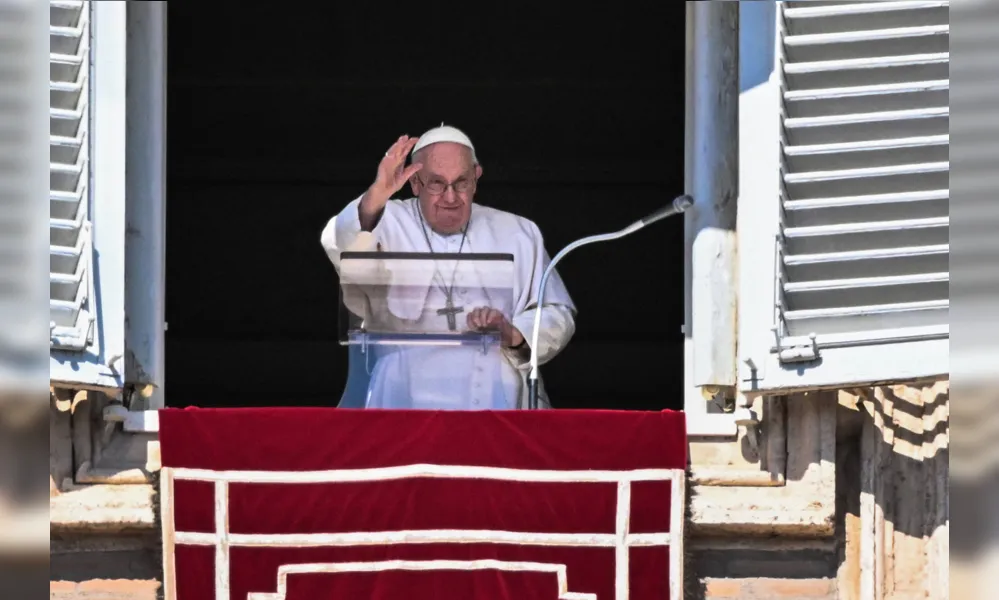Pope Francis waves from the window of the apostolic palace during the weekly Angelus prayer on March 12, 2023 in The Vatican. (Photo by Tiziana FABI / AFP)