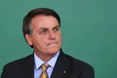 (FILES) In this file photo taken on November 17, 2020 Brazilian President Jair Bolsonaro gestures during the commemoration of the 54th anniversary of the creation of Brazil's Tourism Board (EMBRATUR) at Planalto Palace in Brasilia. - Brazil's Supreme Tribunal approved in a plenary session on April 14, 2021, the installation of a Senate's commission to investigate possible "omissions" from president Jair Bolsonaro in his handling of the covid-19 pandemic. (Photo by EVARISTO SA / AFP)