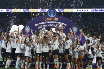 Corinthians' players celebrate with the trophy after winning the women's Brazilian Championship 2023 final match between Corinthians and Ferroviaria at Neo Quimica Arena in Sao Paulo, Brazil, on September 10, 2023. (Photo by Miguel Schincariol / AFP)