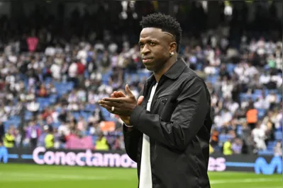 Real Madrid's Brazilian forward Vinicius Junior greets the audience prior the Spanish league football match between Real Madrid CF and Rayo Vallecano de Madrid at the Santiago Bernabeu stadium in Madrid on May 24, 2023. Vinicius drew global support after making a stand against racist abuse he received on May 21 from Valencia supporters at their Mestalla stadium. (Photo by JAVIER SORIANO / AFP)