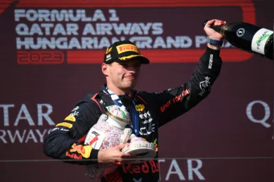 Red Bull Racing's Dutch driver Max Verstappen celebrates on the podium after the Formula One Hungarian Grand Prix at the Hungaroring race track in Mogyorod near Budapest on July 23, 2023. (Photo by Ferenc ISZA / AFP)