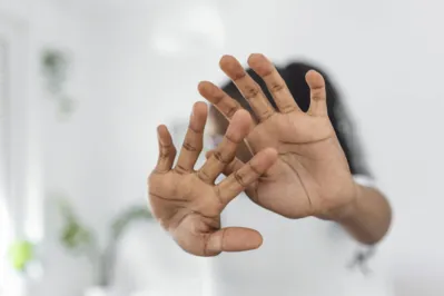 Woman defending herself from attack. Stop. Hands outstretched. campaign stop violence against women. African American woman raised her hand for dissuade with copy space
