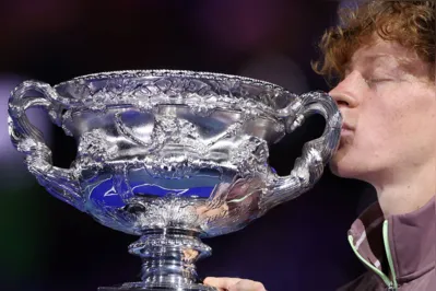 Italy's Jannik Sinner kisses the Norman Brookes Challenge Cup trophy after defeating Russia's Daniil Medvedev in the men's singles final match on day 15 of the Australian Open tennis tournament in Melbourne on January 29, 2024. (Photo by Martin KEEP / AFP) / -- IMAGE RESTRICTED TO EDITORIAL USE - STRICTLY NO COMMERCIAL USE --