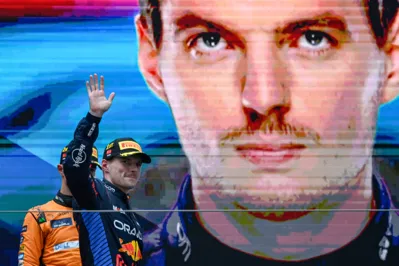 Red Bull Racing's Dutch driver Max Verstappen celebrates on the podium during the Formula One Chinese Grand Prix at the Shanghai International Circuit in Shanghai on April 21, 2024. (Photo by PEDRO PARDO / AFP)