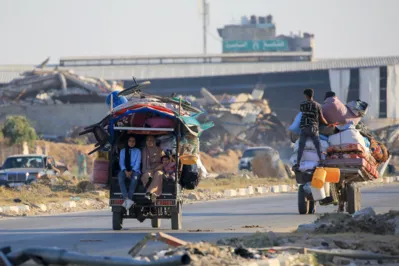 Palestinians take to the road in Al-Maghazi as they flee their displacement camps due to  heavy Israeli bombardment of the central Gaza Strip on June 5, 2024, amid the ongoing conflict between Israel and the Palestinian militant group Hamas. Israel's military pounded central Gaza with heavy air strikes on June 5 as international talks to secure a truce and hostage release deal resumed. (Photo by Eyad BABA / AFP)