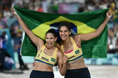 Brazil's #02 Eduarda Santos Lisboa and Brazil's #01 Ana Patricia Silva Ramos celebrate after winning the women's gold medal beach volleyball match between Brazil and Canada during the Paris 2024 Olympic Games at the Eiffel Tower Stadium in Paris on August 9, 2024. (Photo by CARL DE SOUZA / AFP)