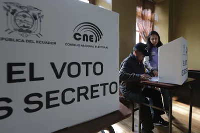A man votes at a polling station during the presidential election in Quito on February 9, 2025. Some 14 million Ecuadorans began voting under tight security Sunday, choosing who will lead their violence-wracked Andean nation through its worst crisis in half a century. (Photo by ARMANDO PRADO / AFP)