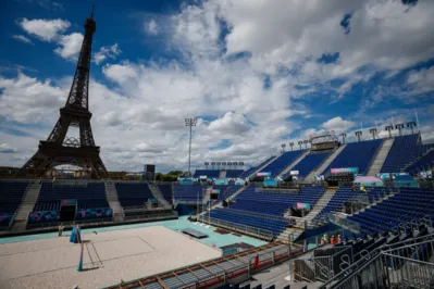 This photograph shows the Eiffel Tower behind the stands at the construction site of the Eiffel Tower Stadium for the upcoming Paris 2024 Olympics and Paralympic Games which will host the Beach Volleyball and men's Blind Football competitions, at the Champ-De-Mars in Paris on July 10, 2024. The Champ de Mars and the Trocadero, located on either side of the Eiffel Tower, will host several events of the Paris Olympic and Paralympic Games, on July 10, 2024. (Photo by Dimitar DILKOFF / AFP)