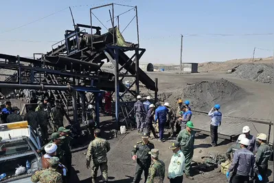 A handout picture provided by the Iranian Red Crescent (RCS) shows security forces gathered at the scene of a blast at a coal mine in Tabas in Iran's Khorasan province on September 22, 2024. The blast caused by a gas leak at the coal mine in eastern Iran has killed at least 30 people, state media said on September 22, with more than 20 others reported missing. (Photo by Iranian Red Crescent / AFP) / == RESTRICTED TO EDITORIAL USE - MANDATORY CREDIT "AFP PHOTO / HO / IRANIAN RED CRESCENT" - NO MARKETING NO ADVERTISING CAMPAIGNS - DISTRIBUTED AS A SERVICE TO CLIENTS ===
