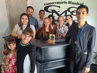 Alunos premiados, do Conservatório Carlos Gomes, com seus professores e familiares