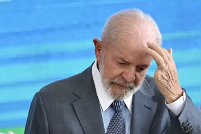 (FILES) Brazilian President Luiz Inacio Lula da Silva attends the swearing-in ceremony of new Minister of Human Rights Macae Evaristo at Planalto Palace in Brasilia, on September 27, 2024. Brazilian President Luiz In?cio Lula da Silva canceled his trip to Russia for the BRICS summit after suffering a domestic accident, although he will participate by videoconference, the presidency informed on October 20, 2024. (Photo by EVARISTO SA / AFP)