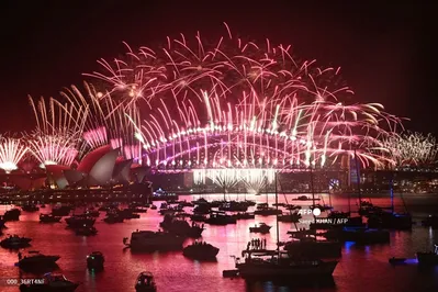 Fireworks light up the midnight sky over Sydney Harbour Bridge and Sydney Opera House during 2025 New Year?s Day celebrations in Sydney on January 1, 2025. (Photo by Saeed KHAN / AFP)