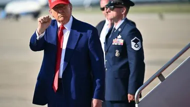 US President Donald Trump pumps his fist after stepping off Air Force One at Joint Base Andrews in Maryland on June 21, 2025 upon return from his golf club in Bedminster, New Jersey. (Photo by Mandel NGAN / AFP)