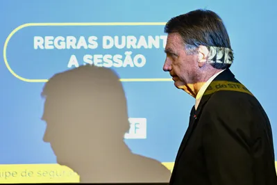 Former Brazilian President Jair Bolsonaro leaves the court room after taking the stand for the first time in his Supreme Court trial for allegedly plotting a coup in January 2023, in Brasilia, June 10, 2025. Bolsonaro on Tuesday denied any involvement in an alleged coup plot, as he took the stand for the first time in his high-stakes trial. The 70-year-old is answering questions from lawyers and judges on his alleged role in a "criminal organization" that plotted to wrest power from leftist Luiz Inacio Lula da Silva, who narrowly beat Bolsonaro at the ballot box in 2022. Bolsonaro was the sixth of eight accused to take the stand for in-person questioning that started on Monday. (Photo by Evaristo SA / AFP)