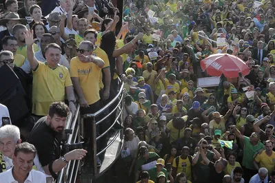 Brazil's former President (2019-2022) Jair Bolsonaro waves at supporters during a march in favor of amnesty for those involved in acts against democracy on January 8, 2023, in Brasilia, Brazil, on May 7, 2025. (Photo by SERGIO LIMA / AFP)