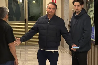 This screen grab from AFPTV video footage shows former Brazilian President Jair Bolsonaro arriving at the Liberal Party headquarters in Brasilia on July 23, 2025. "You know I can't talk," Bolsonaro said to journalists upon arriving at the Liberal Party's headquarters to meet with members of his party. Bolsonaro is waiting for Supreme Court Judge Alexandre de Moraes' decision on whether or not to order his preventive detention. De Moraes has threatened him with imprisonment, arguing that the sharing of a speech of his by online users was a "violation" of a social media ban. (Photo by Jose OSORIO / AFP)