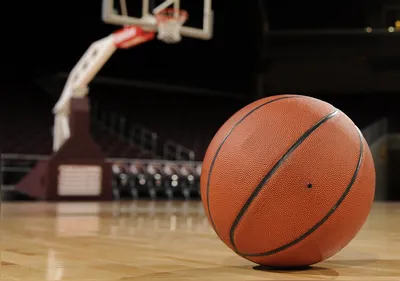 Basketball on the floor of a indoor court.