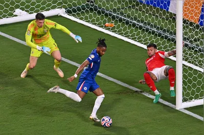 Chelsea's French striker #18 Christopher Nkunku scores his team's second goal during the FIFA Club World Cup 2025 round of 16 football match between Portugal's Benfica and England's Chelsea at the Bank of America Stadium in Charlotte on June 28, 2025. (Photo by ANGELA WEISS / AFP)