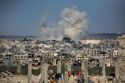 This picture taken from western Jabalia in the central Gaza Strip shows smoke billowing east of Gaza City, in the central Gaza Strip following Israeli strikes on July 13, 2025. Delegations from Israel and the Palestinian militant Hamas group have now spent a week trying to agree on a temporary truce to halt 21 months of devastating fighting in the Gaza Strip. (Photo by Bashar TALEB / AFP)