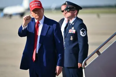 US President Donald Trump pumps his fist after stepping off Air Force One at Joint Base Andrews in Maryland on June 21, 2025 upon return from his golf club in Bedminster, New Jersey. (Photo by Mandel NGAN / AFP)