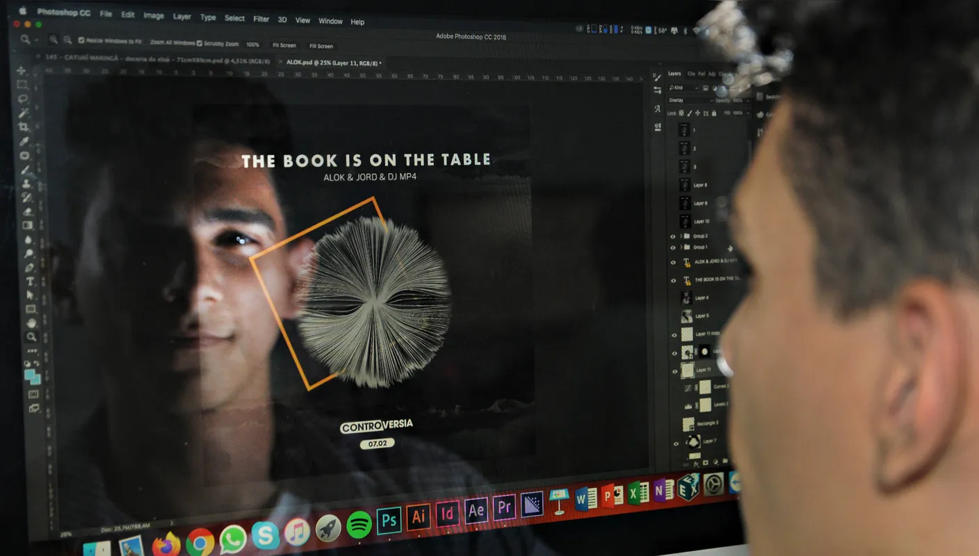 Clécio Teles dos Santos Filho com a arte que produziu para Alok: um livro aberto com folhas ao vento trabalhadas no computador