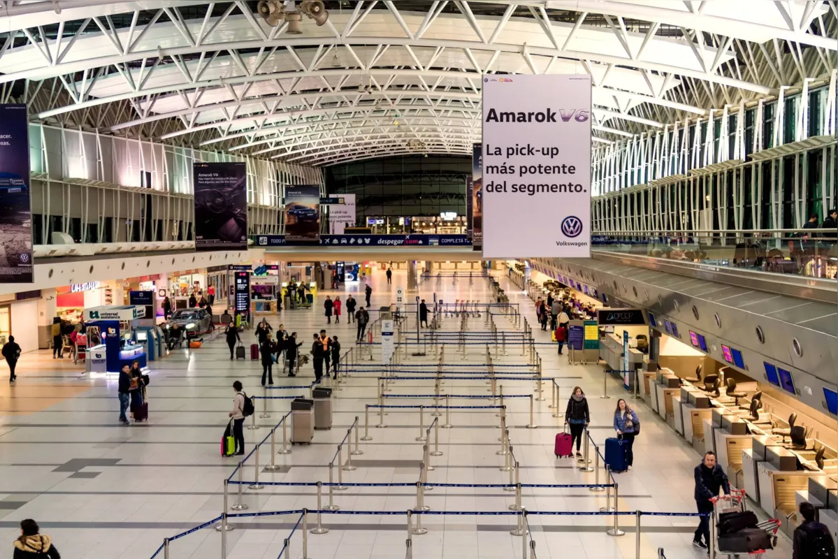 Buenos Aires, Argentina - August 19, 2018: Passengers check in at the desks of the Ezeiza International Airport in the central hall of terminal A