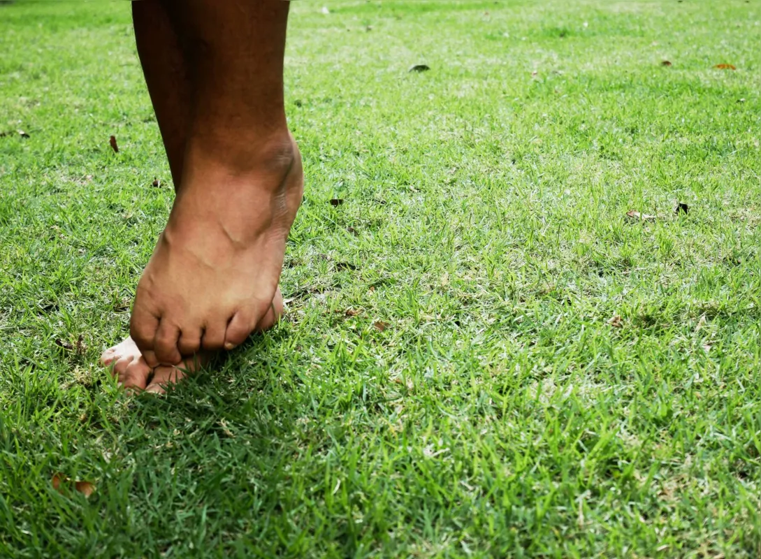 Itching from foot fungus on grass in the park.