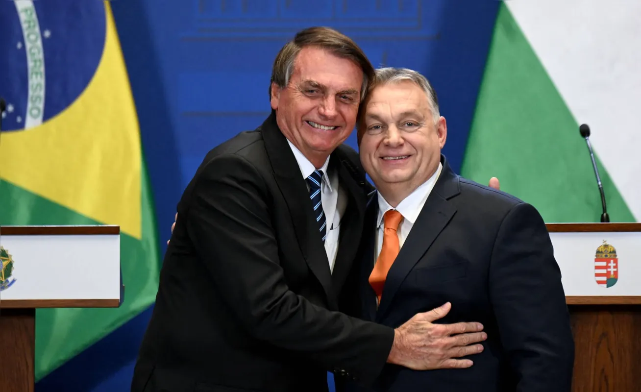Hungary's Prime Minister Viktor Orban (R) and Brazil's President Jair Bolsonaro hug after giving a joint press conference on February 17, 2022 in Budapest, Hungary. (Photo by Attila KISBENEDEK / AFP)