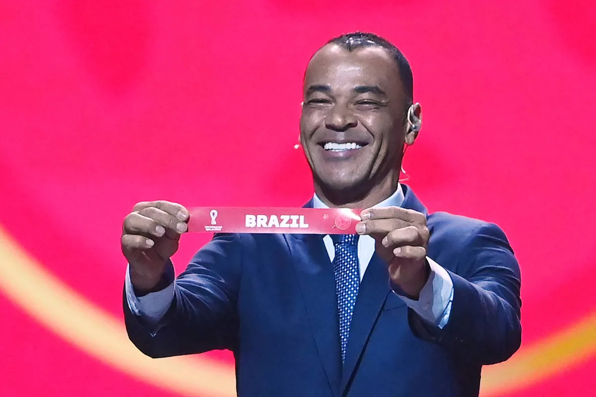 Former Brazilian footballer and World Cup winner Cafu displays the name of Brazil during the draw for the 2022 World Cup in Qatar at the Doha Exhibition and Convention Center on April 1, 2022. (Photo by FRANCK FIFE / AFP)