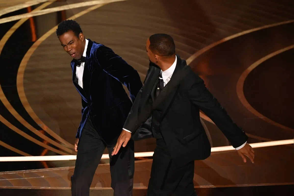 (FILES) In this file photo taken on March 27, 2022 US actor Will Smith (R) slaps US actor Chris Rock onstage during the 94th Oscars at the Dolby Theatre in Hollywood, California. - Will Smith has tendered his resignation from the body that awards the Oscars after his attack on Chris Rock during the weekend ceremony, a statement said April 1, 2022. (Photo by Robyn Beck / AFP)