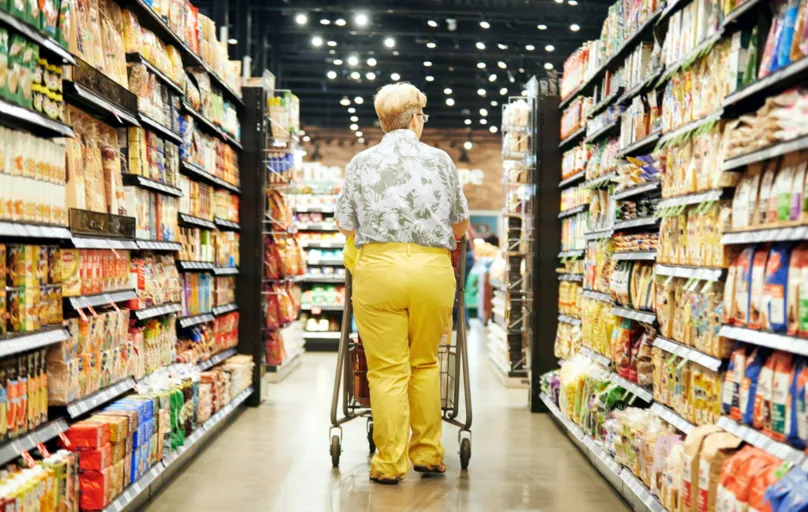 Rearview shot of a mature woman shopping in a grocery store