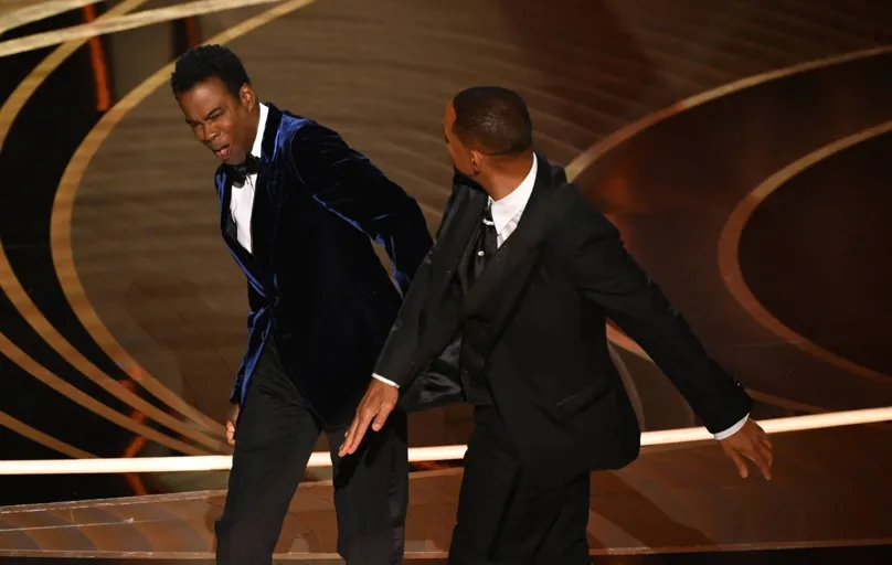 (FILES) In this file photo taken on March 27, 2022 US actor Will Smith (R) slaps US actor Chris Rock onstage during the 94th Oscars at the Dolby Theatre in Hollywood, California. - Will Smith has tendered his resignation from the body that awards the Oscars after his attack on Chris Rock during the weekend ceremony, a statement said April 1, 2022. (Photo by Robyn Beck / AFP)