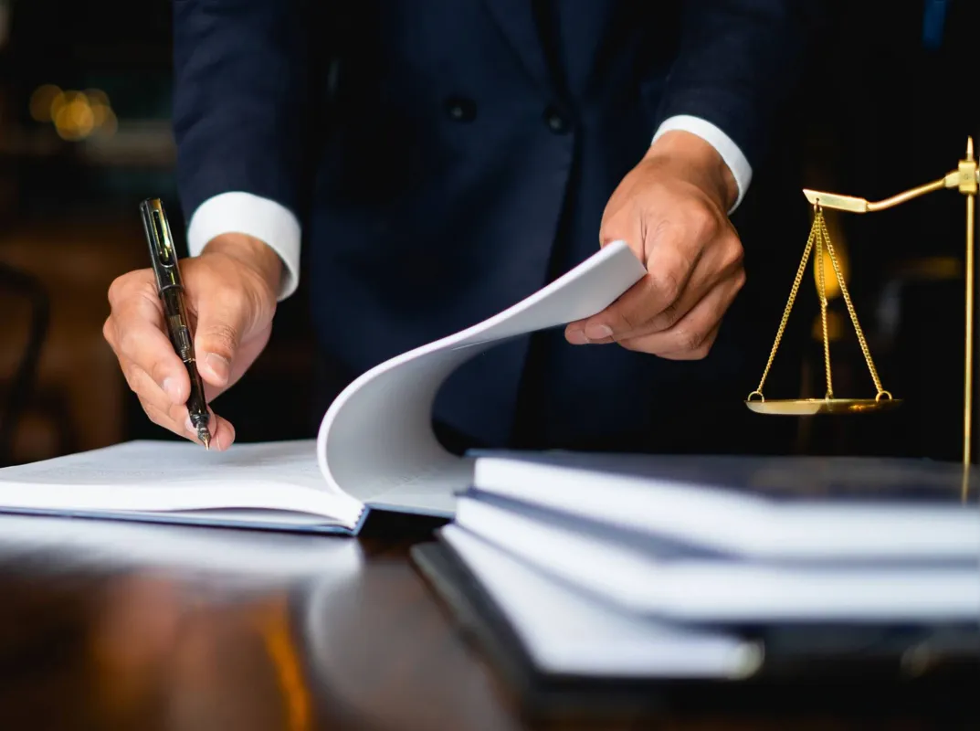 Close up lawyer businessman working or reading lawbook in office workplace for consultant lawyer concept.