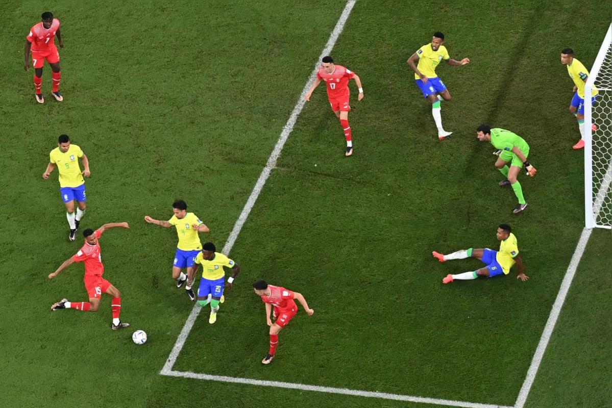 Switzerland's midfielder #15 Djibril Sow (bottom, L) attempts a shot during the Qatar 2022 World Cup Group G football match between Brazil and Switzerland at Stadium 974 in Doha on November 28, 2022. (Photo by Jewel SAMAD / AFP)