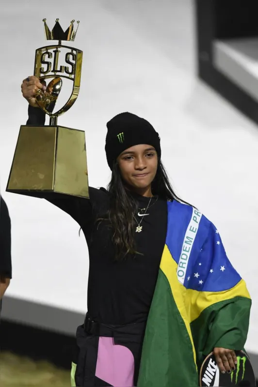 Brazilian skateboarder Rayssa Leal celebrates with the trophy after winning the Street League Skateboarding world championship women's final in Rio de Janeiro, Brazil, on November 6, 2022. (Photo by MAURO PIMENTEL / AFP)