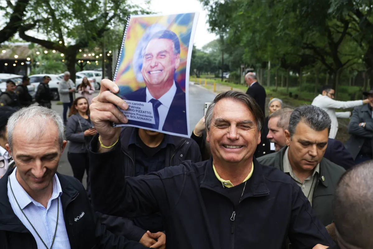 Brazilian former President Jair Bolsonaro gestures after an event held by the Liberal Party at the Auditorio Dante Barone in Porto Alegre, Brazil on June 23, 2023. (Photo by SILVIO AVILA / AFP)