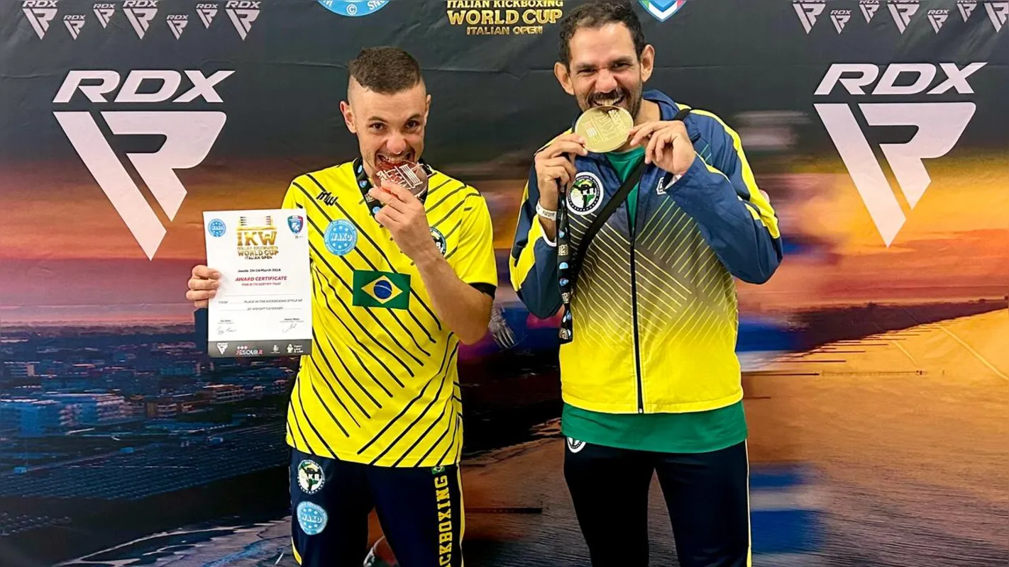 Guilherme Belarmino (D) exibe a medalha de ouro da Copa do Mundo de kickboxing