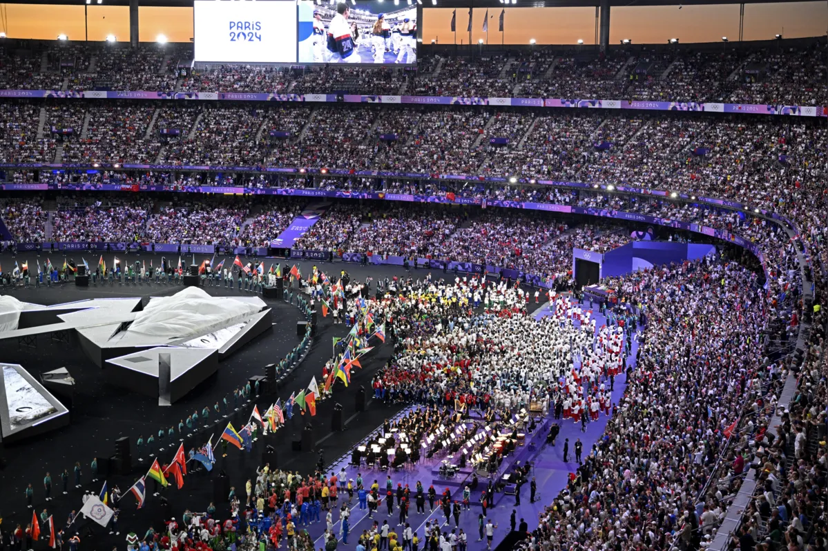 Athletes take part in the athletes parade during the closing ceremony of the Paris 2024 Olympic Games at the Stade de France, in Saint-Denis, in the outskirts of Paris, on August 11, 2024. (Photo by WANG Zhao / AFP)