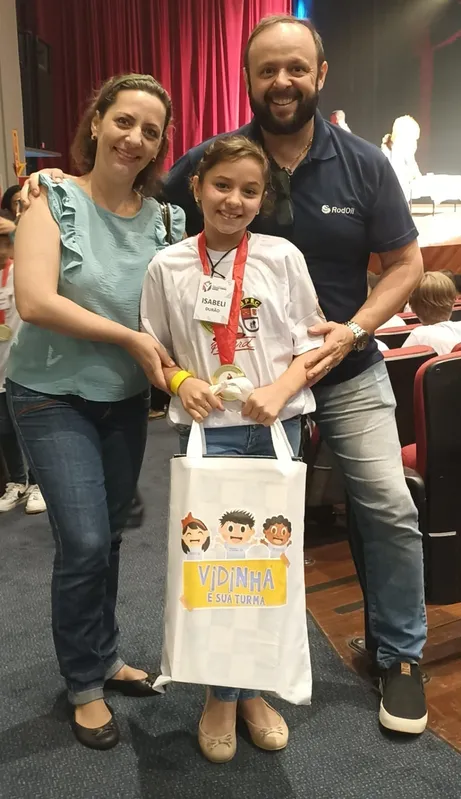 Isabeli Furlan Durão com os pais, Heloise e Vinícius, que comemoram a premiação da filha no concurso de redação