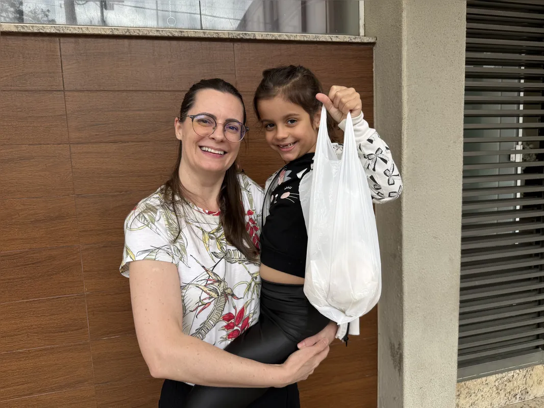Tatiely é acompanhada da sobrinha, Maria Júlia, todos os anos na fila do bolo: 'seguir com a tradição'